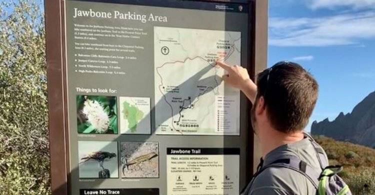 A trailhead sign with information and maps at a family-friendly hiking spot